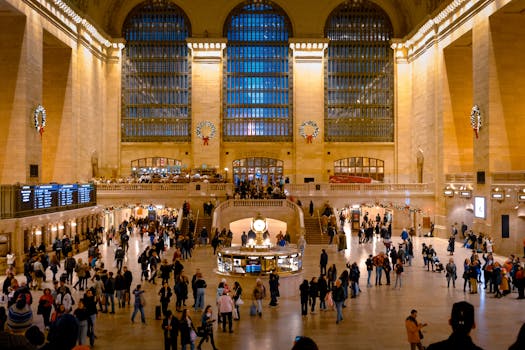 Crowd in Grand Central Terminal, New York, showcasing iconic architecture and lively atmosphere.